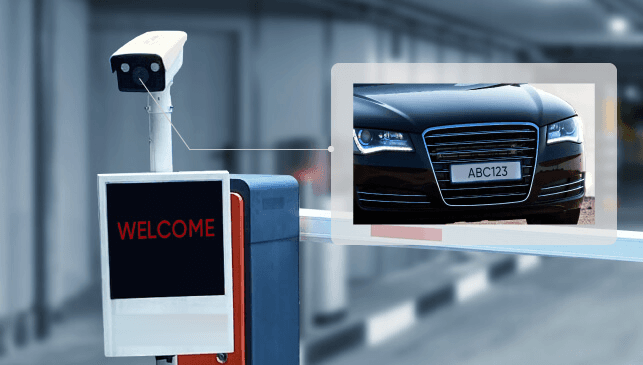 Vehicle entry terminal reading an approaching vehicle's number plate at a controlled barrier